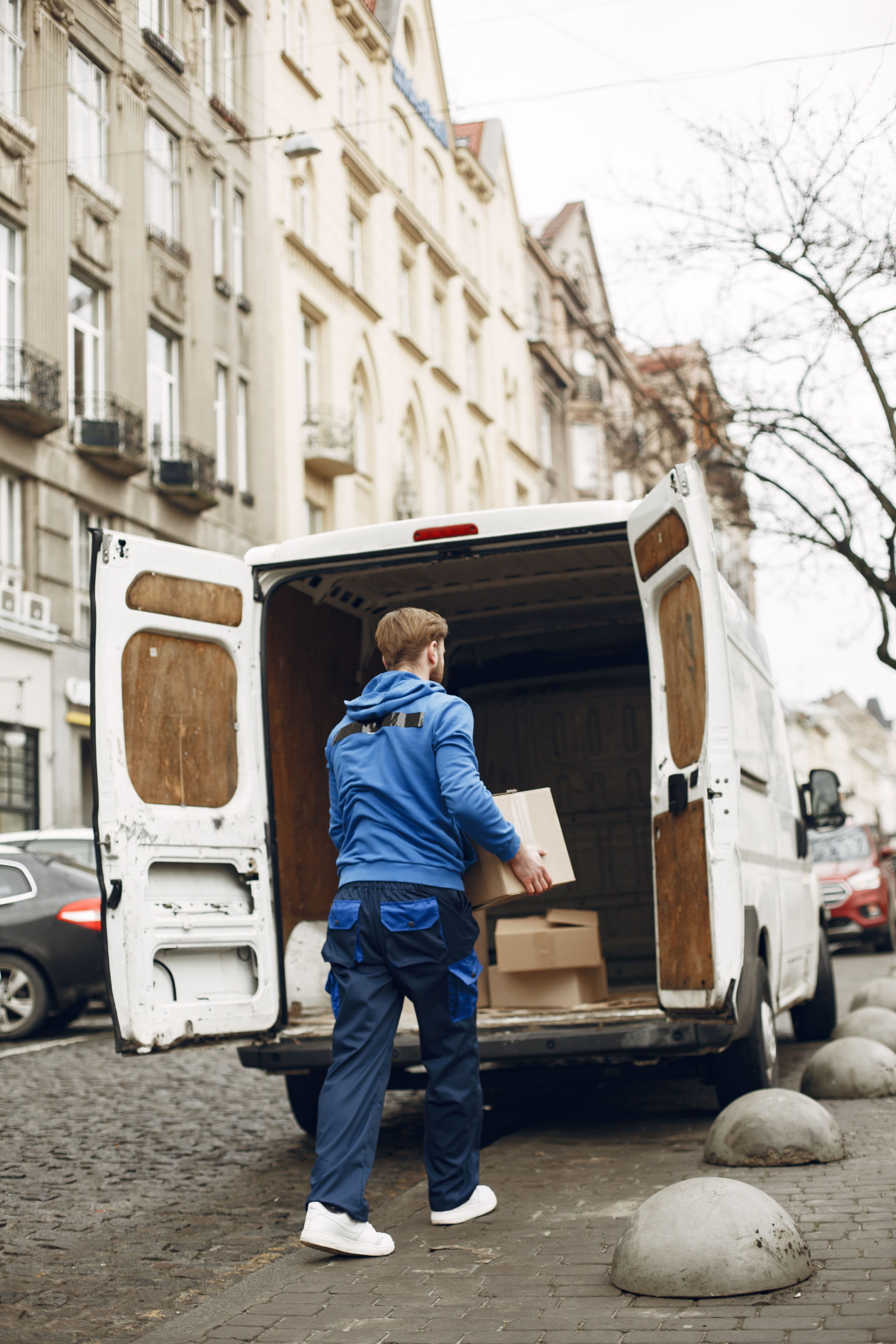 Courier loading boxes into a van